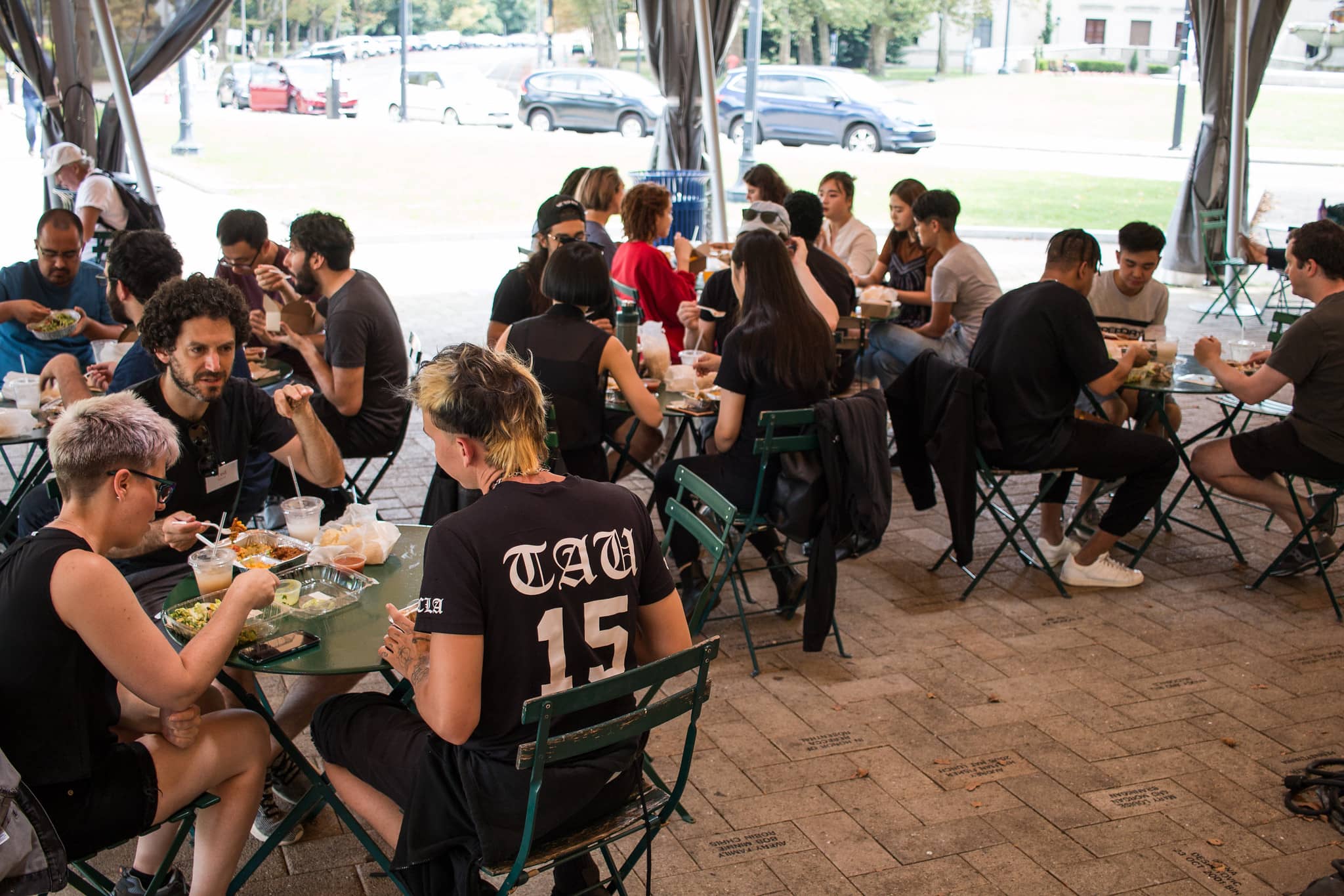 Participants sitting outside eating lunch together