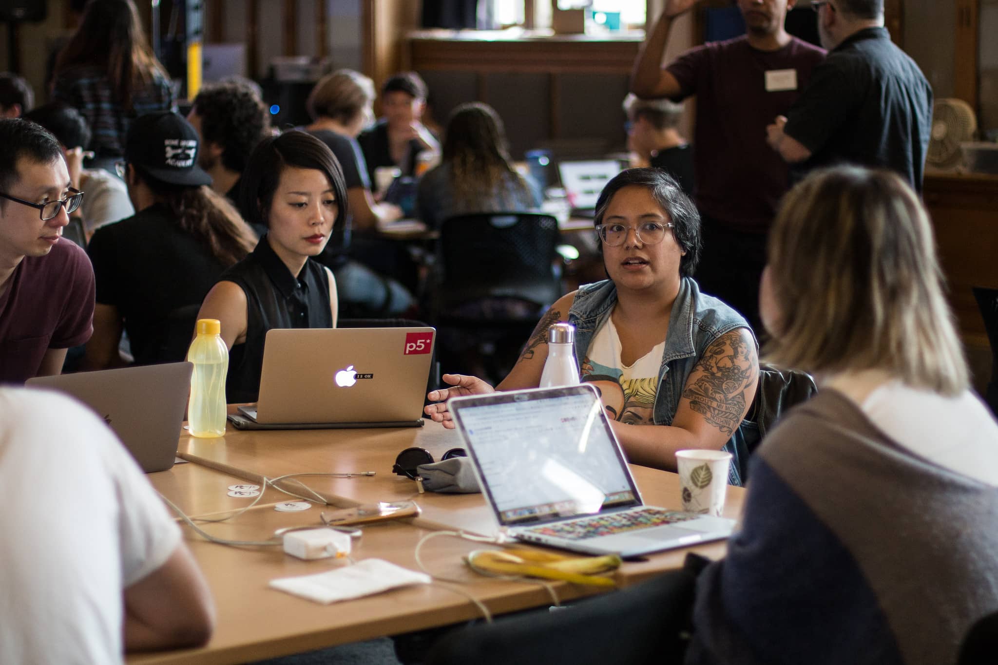 People gathered around computers at a desk